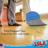 Fine flagged tips trap dirt and dust as Lola Big Angle Broom sweeps debris on hardwood floor at ground level