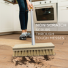 Non-scratch coco bristle deck scrub scrubs tough messes as woman mops kitchen hardwood floor, close-up