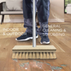 Non-scratch deck scrub scrubs through tough messes as woman mops kitchen hardwood floor while cleaning
