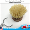 Small Tampico dish brush with natural fiber bristles scrubbing vegetables at the kitchen sink