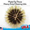 Pot and pan brush replacement head scrubbing a cast iron pan as a kitchen dish cleaning tool