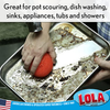 Red scourer scrubbing burnt roasting pan; great for pot scouring, dish washing, sinks, appliances, tubs and showers