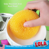 Odor resistant, rust proof orange mesh scourer scrubbing inside a white ceramic mug by hand