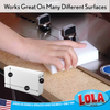 Lola white melamine eraser pad works on many surfaces, shown cleaning kitchen countertop near stainless steel sink