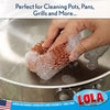 Lola Jumbo Copper Mesh Scourer scrubbing a large stainless steel pan with soapy suds