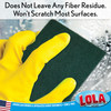 Gloved hand using Lola green scouring pad to clean wet surface; text: no fiber residue, won't scratch most surfaces.
