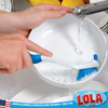 Hand using Lola Pro dish brush to scrub a white bowl under running faucet; American owned family business since 1969