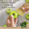 Eco Clean bamboo vegetable brush scrubbing an apple at the sink for cleaning all types of fruits and vegetables